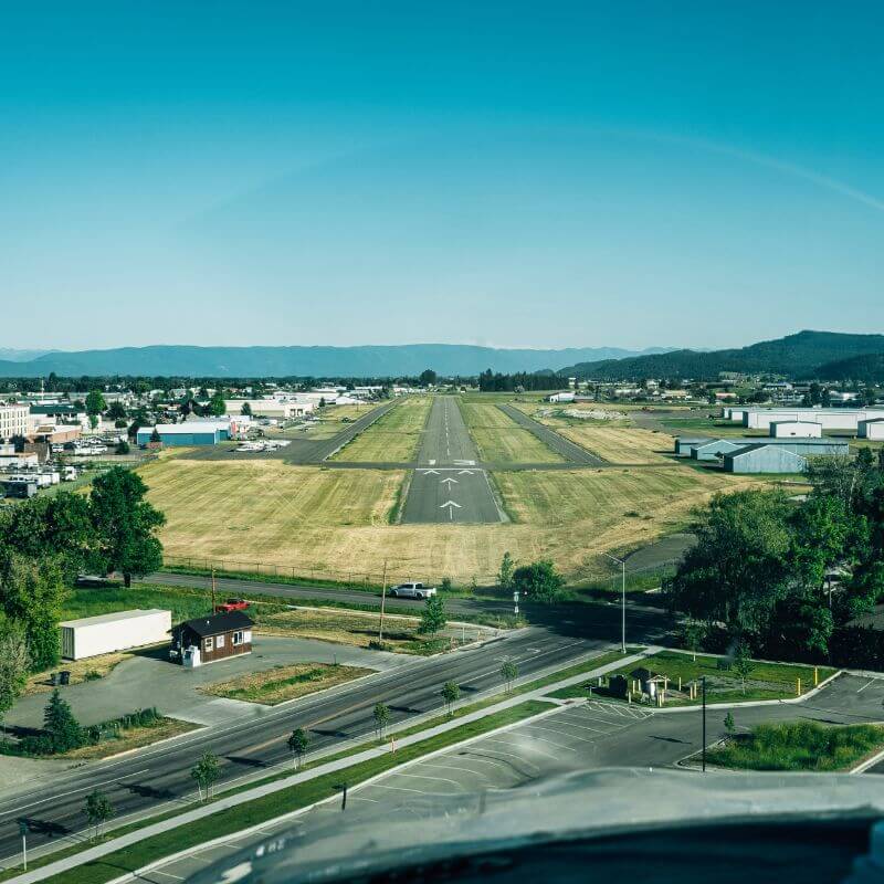 scenic view of greenery a small town and mountains at red eagle aviation 2